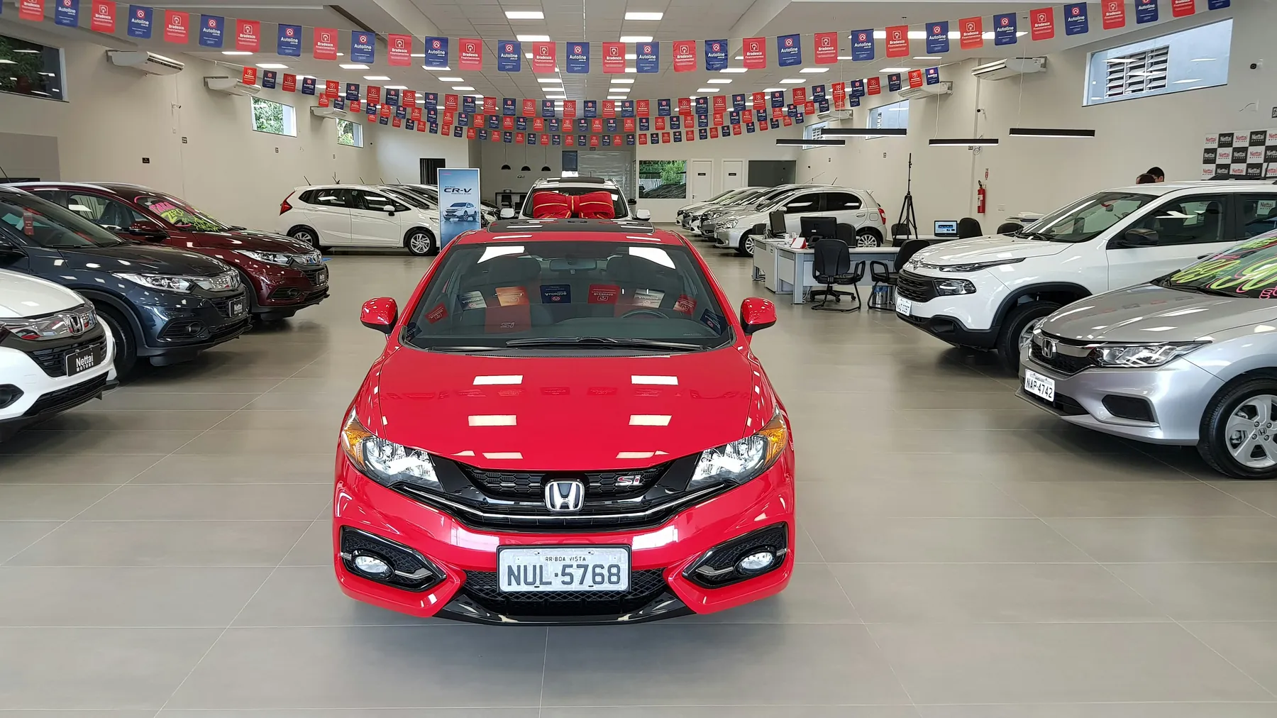 Red car displayed in a dealership
