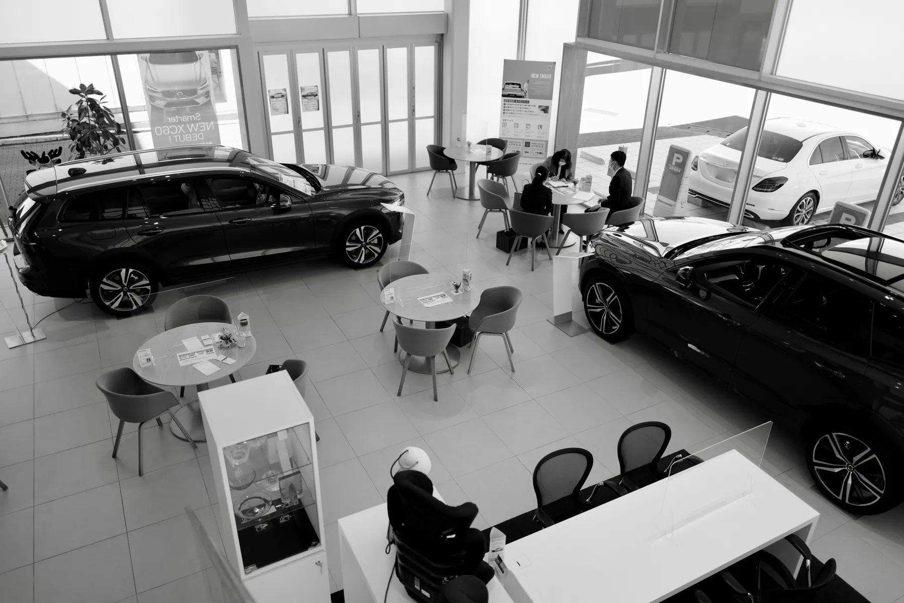 Customers discussing a car inside a showroom