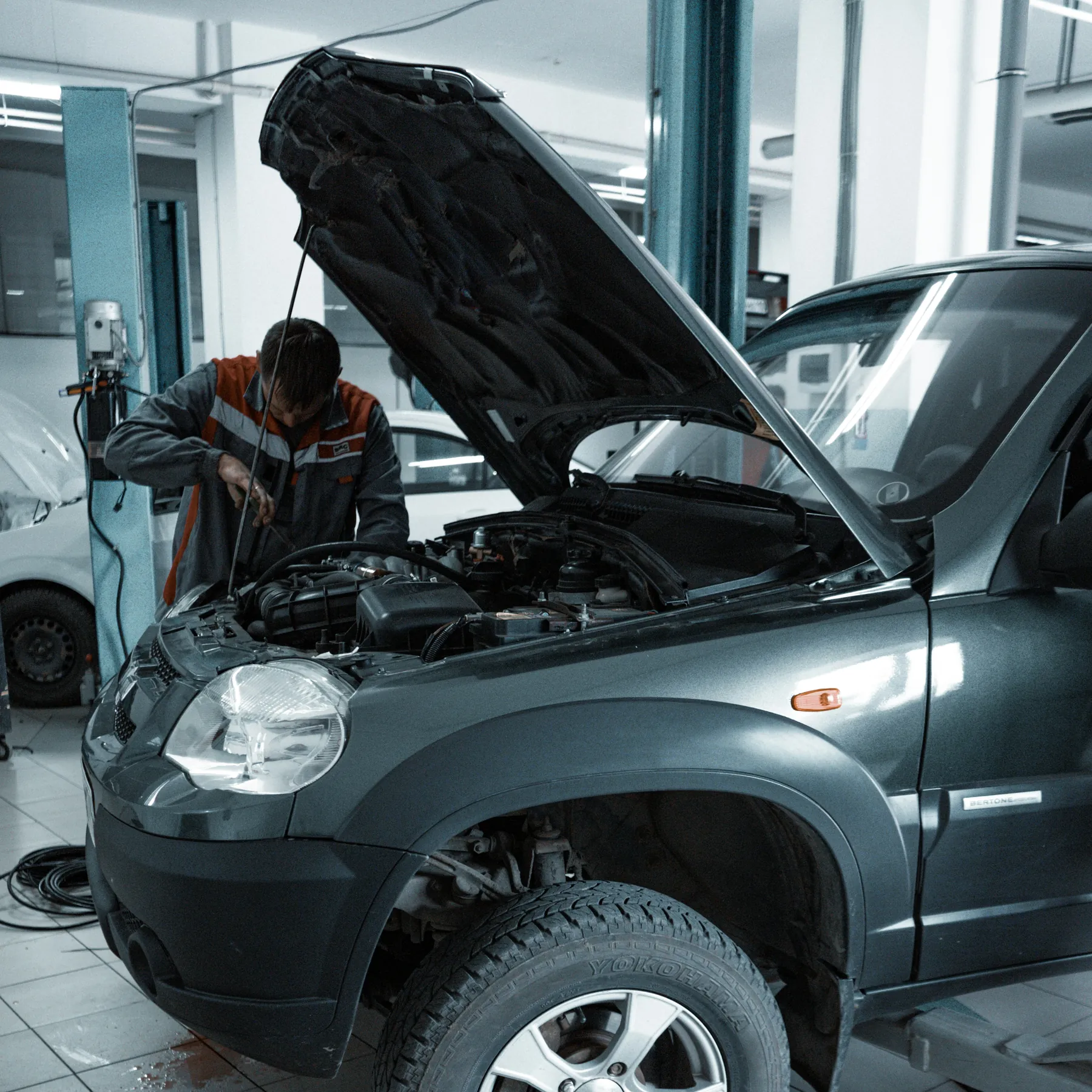 Vehicle in a workshop with its engine bay open