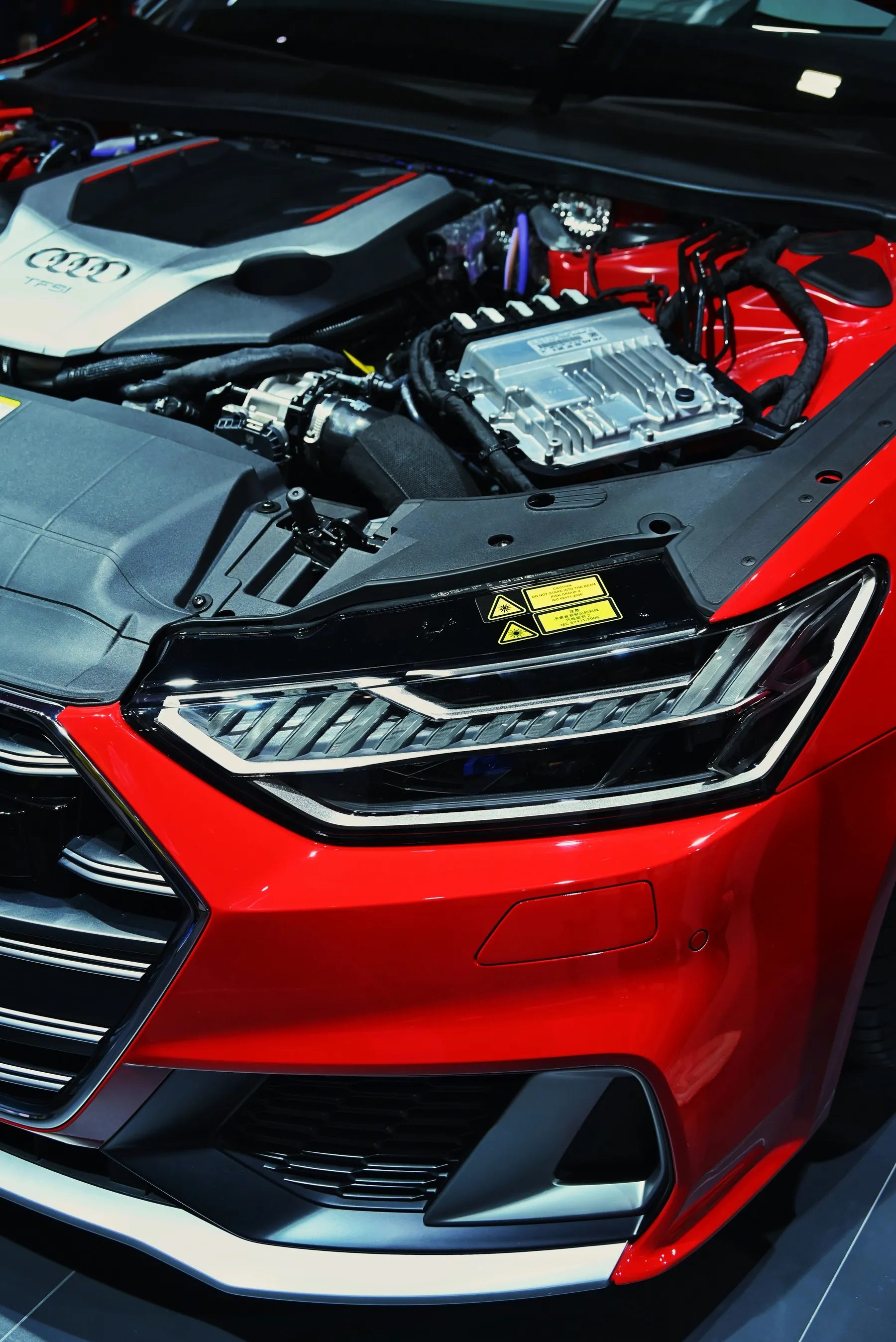 Open engine bay of a modern red car