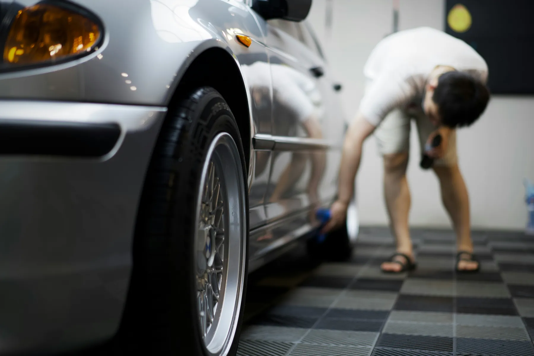 Detailed exterior inspection of a car side panel and wheel