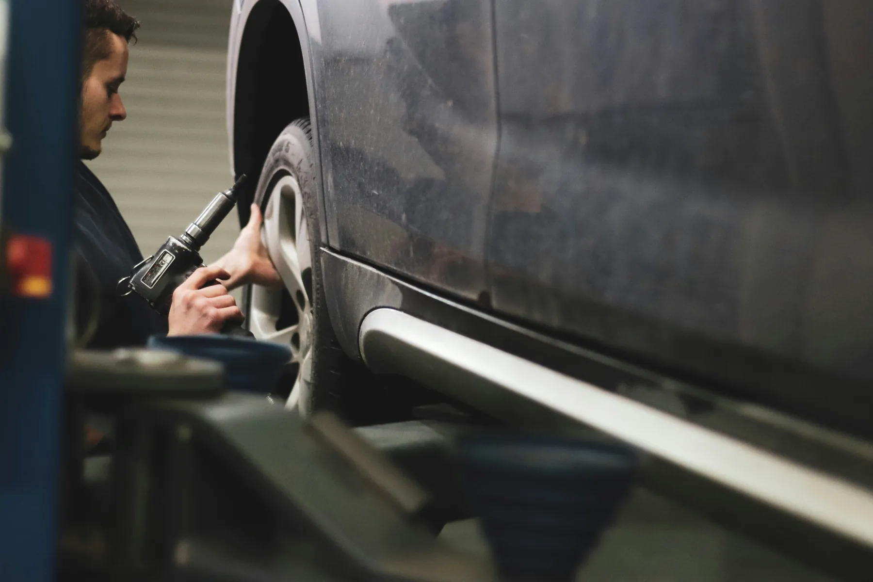 Automotive technician checking a tyre and wheel